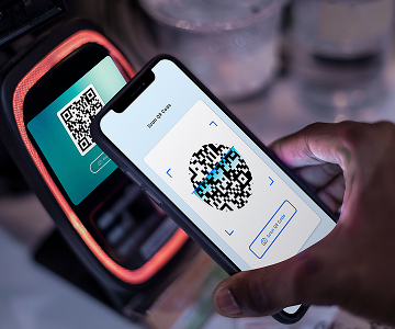 An image of a
            phone scanning a QR-code from another device.