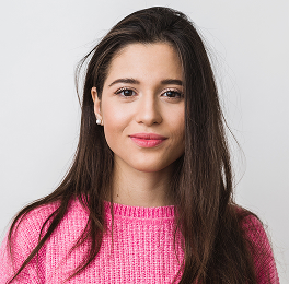 A woman with long, dark hair smiling at the camera.
